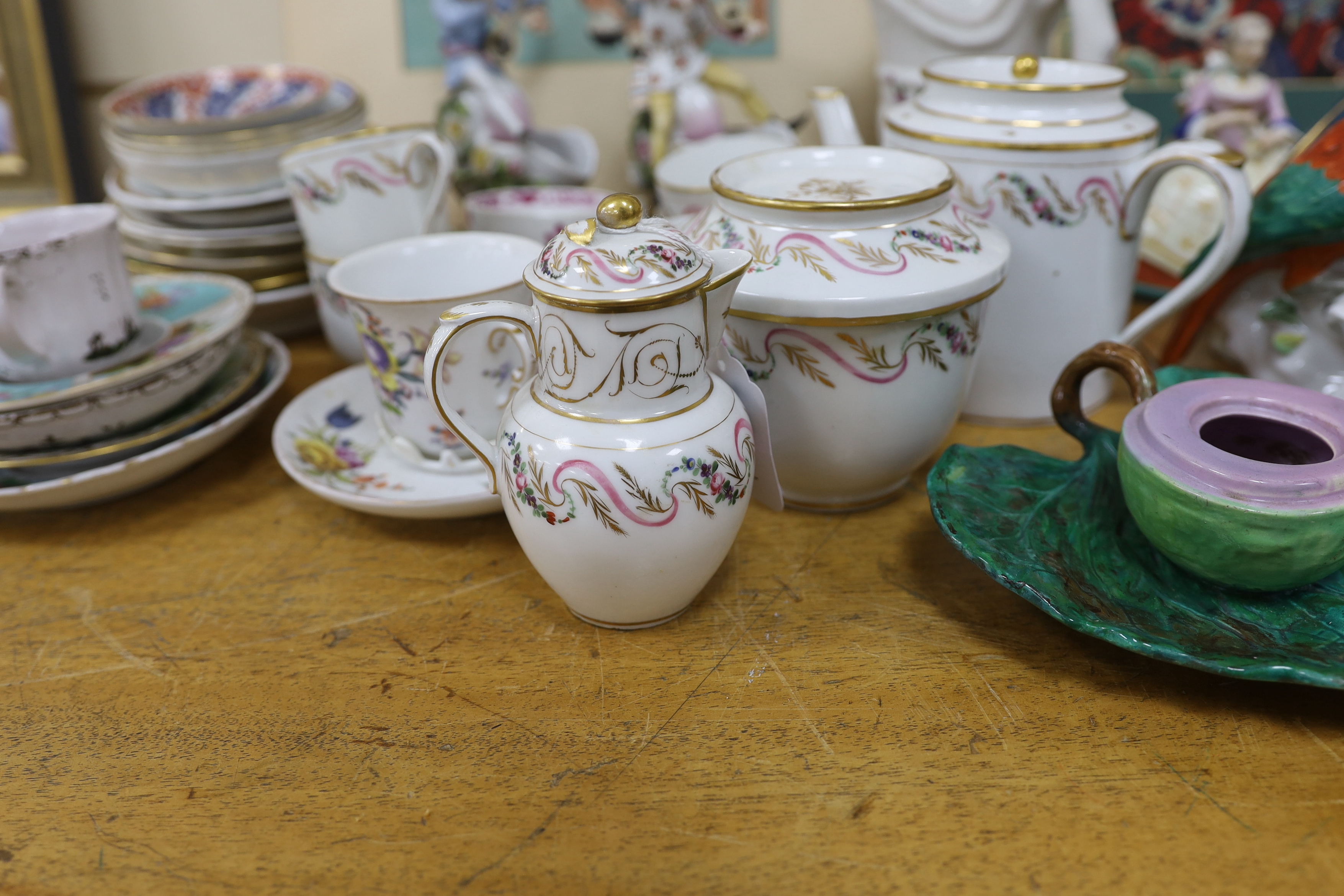 Assorted Continental ceramics, mainly 19th century, including two figures of parrots, two candle holders in the form of musicians, a teapot, jugs, various cups and sauces, etc.